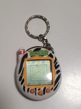 Tamagotchi Connection Keychain - White with Black Zebra Stripes & Orange Accents